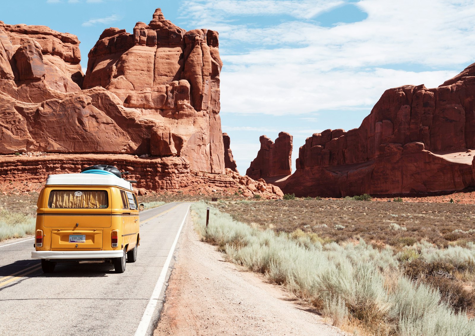 Open road through desert rock formations — moving forward